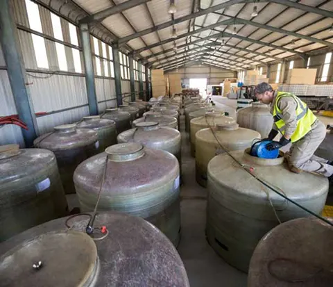 DP worker removing oil from a Tank